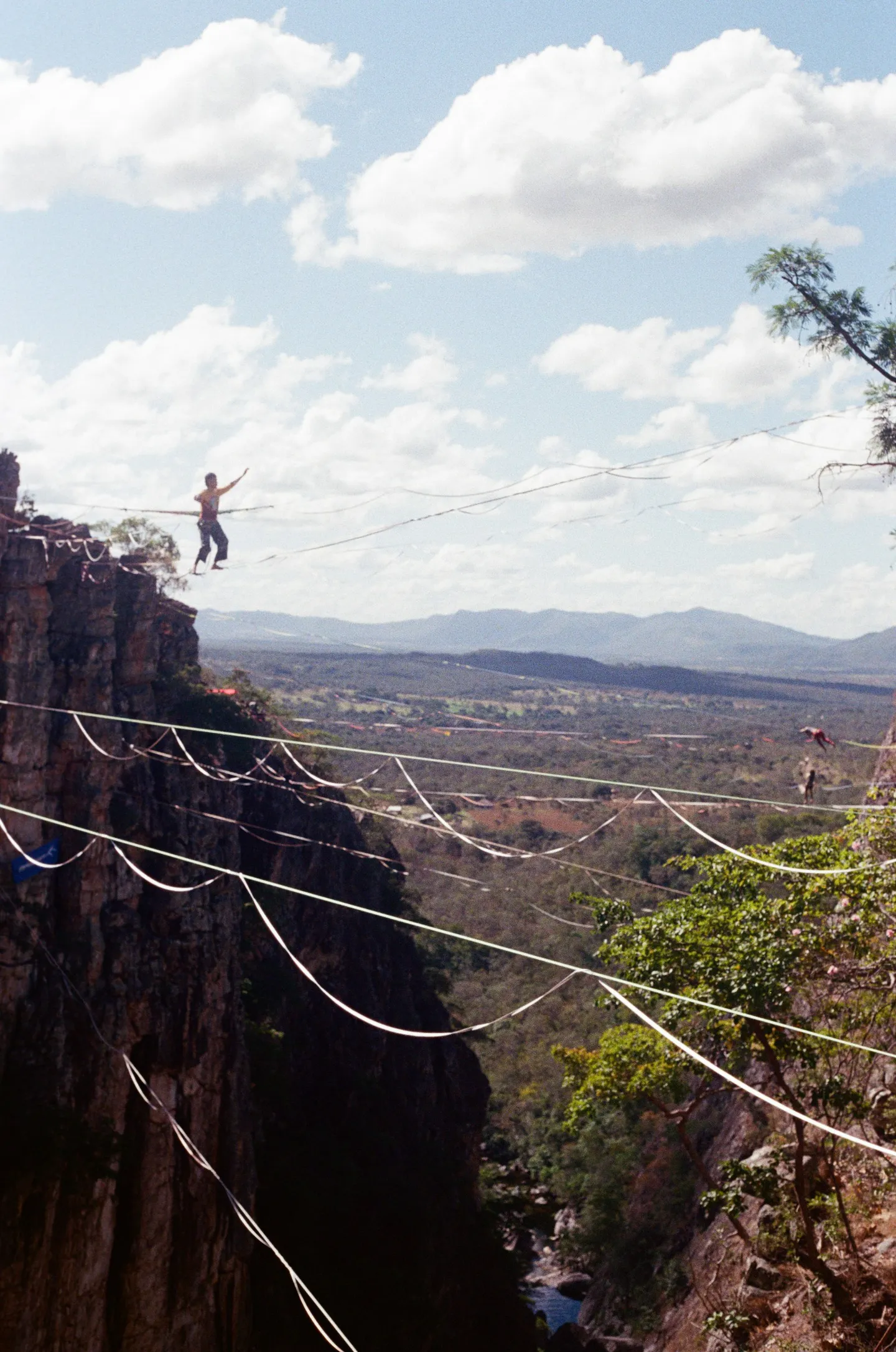 A slackliner crossing a canyon