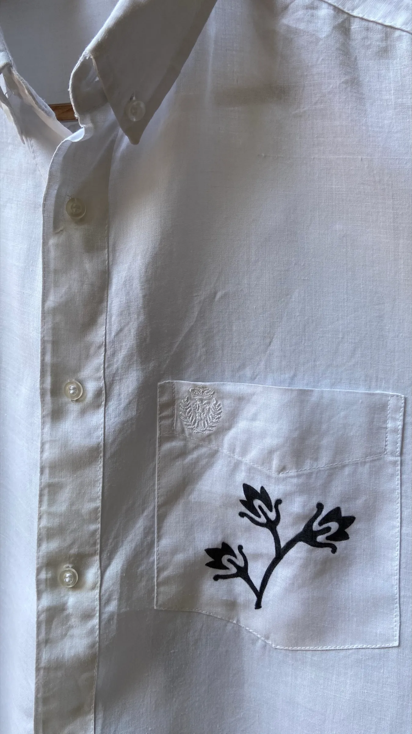 Shirt from the collection against a concrete wall