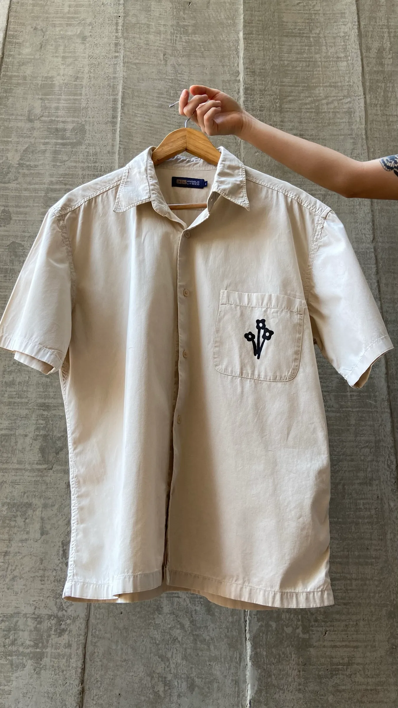 Shirt from the collection against a concrete wall